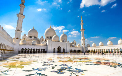 Sheikh Zayed Grand Mosque during Abu Dhabi city tour from Dubai with Ferrari World Yas Island in the background.