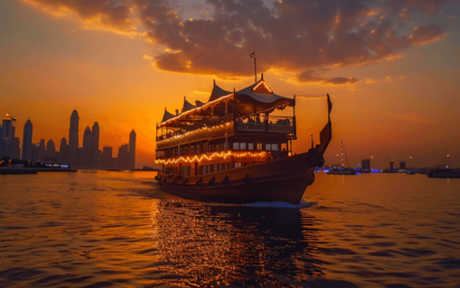 Scenic view of the best dhow cruise Dubai with guests enjoying a Dubai dinner cruise under city lights, highlighting dhow cruise Dubai ticket price value.