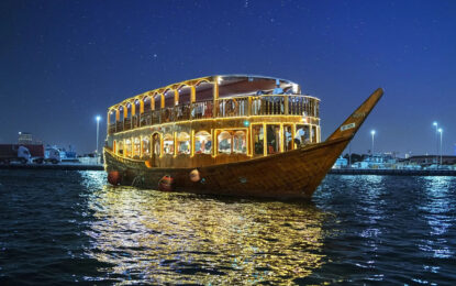 Dhow Cruise 2025: Dubai Evenings You Can’t Miss! › Forever Tourism LLC Traditional dhow cruise sailing through Dubai Marina at night with guests enjoying dinner on board.