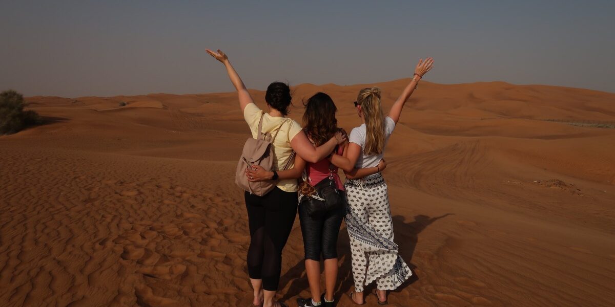 Evening Desert Safari Dubai – Pure Magic Awaits! › Forever Tourism LLC Tourists enjoying an adventurous Evening Desert Safari Dubai with exclusive Desert Safari Dubai Deals during a scenic Desert Evening Safari experience.