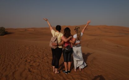 Tourists enjoying an adventurous Evening Desert Safari Dubai with exclusive Desert Safari Dubai Deals during a scenic Desert Evening Safari experience.