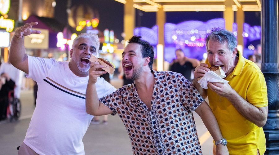 Global Village Last Date – Ends Soon, Don’t Miss Out › Forever Tourism LLC Crowds enjoying cultural shows and food stalls at Global Village before the last date of the season, showcasing Global Village tickets in hand.