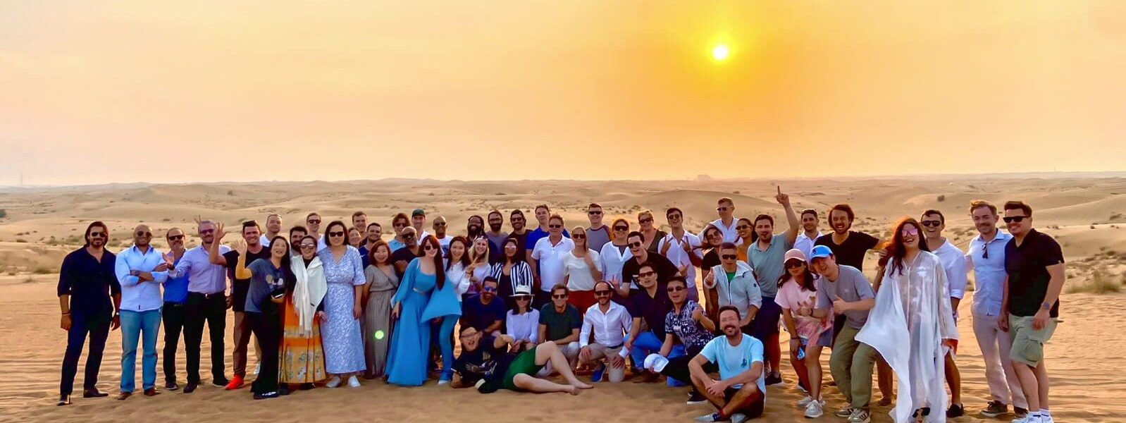 Tourists enjoying desert safari Dubai with camel rides, dune bashing, and traditional desert safari activities in the golden sands of Dubai Desert Safari.