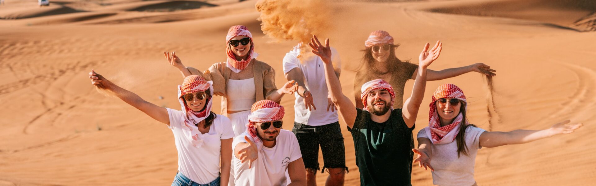 Desert Safari Dubai – This Thrill Ride is a Must-Do › Forever Tourism LLC Tourists enjoying a thrilling Desert Safari Dubai with 4x4 dune bashing on golden sand dunes during a scenic Dubai desert safari adventure.