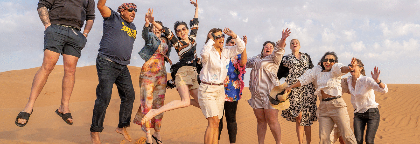 Tourists enjoying an evening desert safari Dubai adventure as part of the Best Dubai Desert Safari packages.