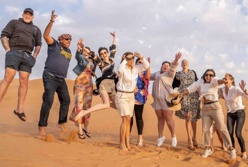 Tourists enjoying an evening desert safari Dubai adventure as part of the Best Dubai Desert Safari packages.