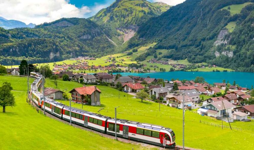 Travel essentials including passport, flight tickets from Dubai to Switzerland, and Switzerland Schengen visa application documents on a desk.