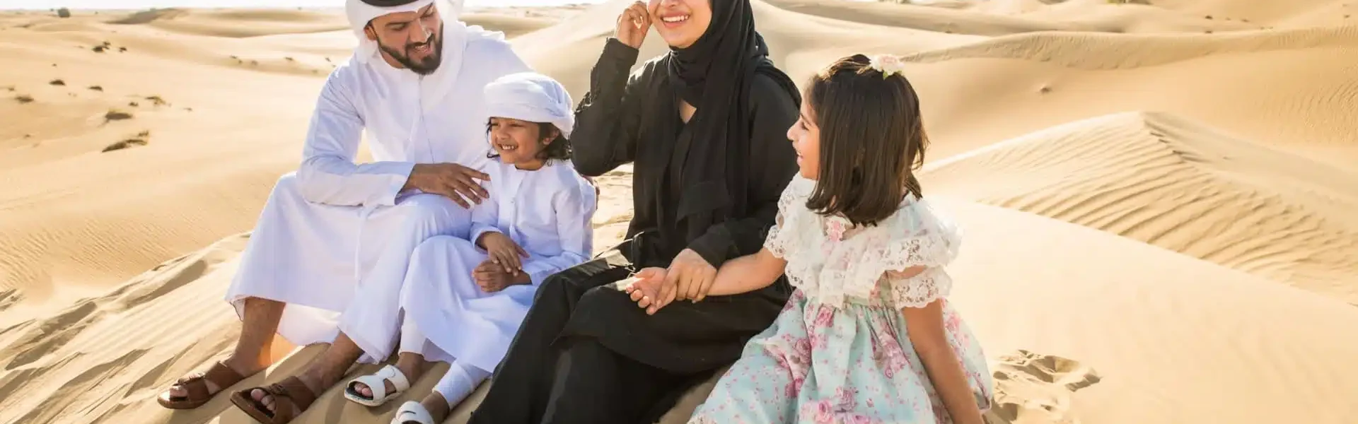 Tourists enjoying exciting Desert Safari Dubai Tours with exclusive Desert Safari Dubai Deals amidst golden sand dunes.