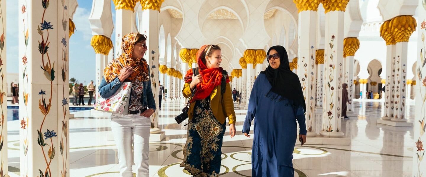 Tourists enjoying a scenic City Tour Abu Dhabi, featuring stops at iconic landmarks, with options for Abu Dhabi city tour from Dubai and Ferrari World visits.