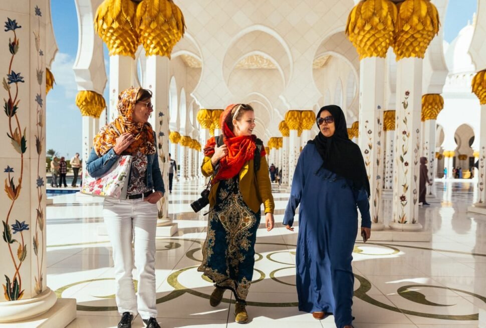 Tourists enjoying a scenic City Tour Abu Dhabi, featuring stops at iconic landmarks, with options for Abu Dhabi city tour from Dubai and Ferrari World visits.