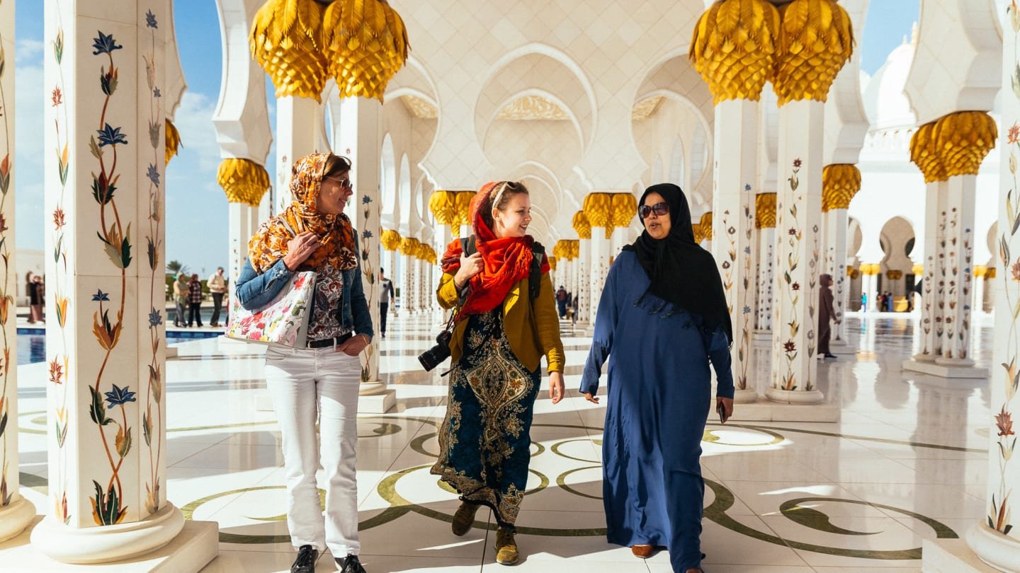 Tourists enjoying a scenic City Tour Abu Dhabi, featuring stops at iconic landmarks, with options for Abu Dhabi city tour from Dubai and Ferrari World visits.