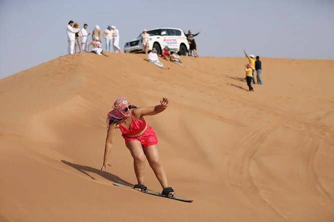 Morning Desert Safari Dubai – Must-do! Top thrill ride of 2025 › Forever Tourism LLC Tourists enjoying a morning desert safari Dubai adventure with dune bashing and camel rides, showcasing the best desert safari in Dubai deals.