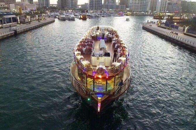 Dubai Marina Dhow Cruise: 500+ Reviews Say Wow! › Forever Tourism LLC Traditional dhow sailing on a Dubai Marina Dhow Cruise with skyline views and evening lights.