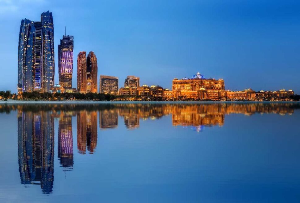 Skyline view promoting Abu Dhabi city tour from Dubai, highlighting the Grand Mosque and Ferrari World attractions.