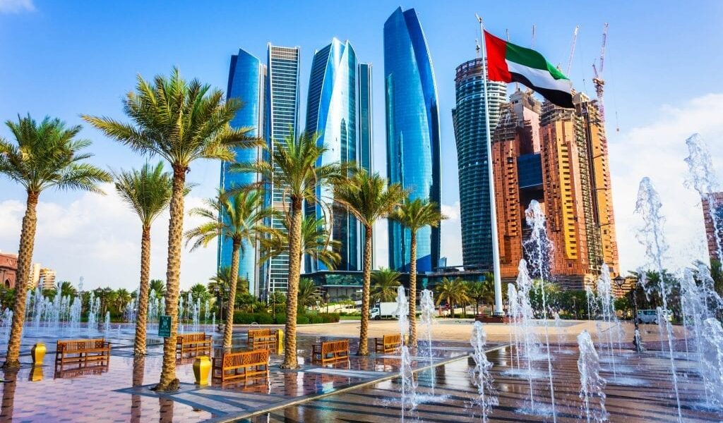 Skyline view of Abu Dhabi City Tour featuring Sheikh Zayed Grand Mosque, Emirates Palace, and the thrilling Ferrari World at Yas Island.
