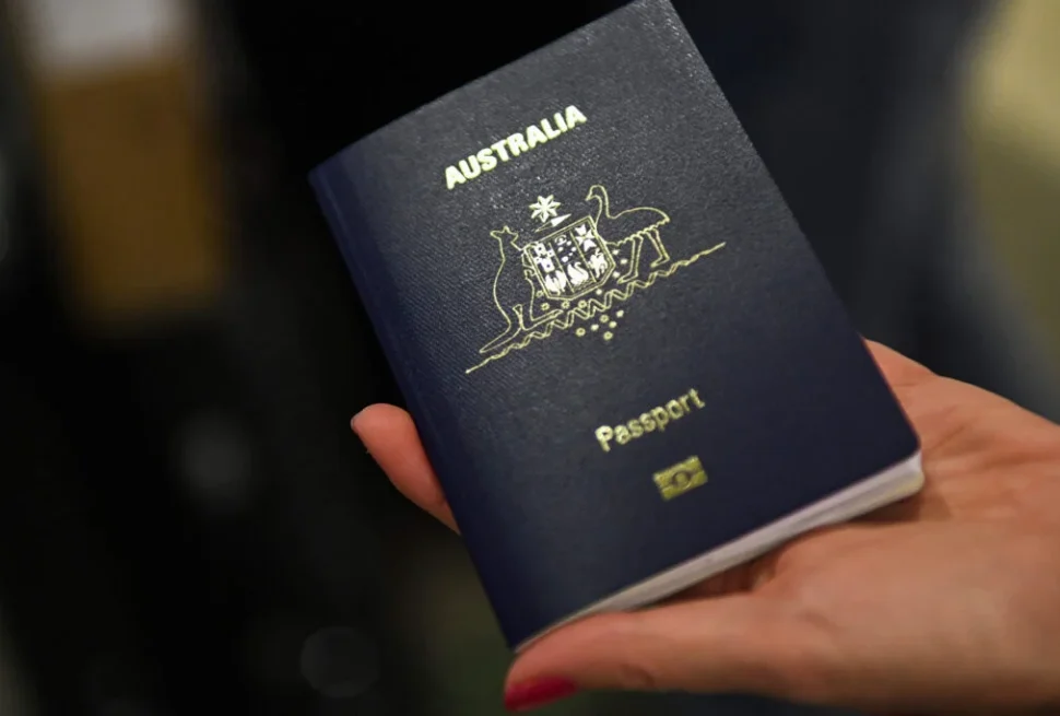 Traveler at airport checking documents for Australia visa application from Dubai with focus on tourist visa process and estimated processing time.