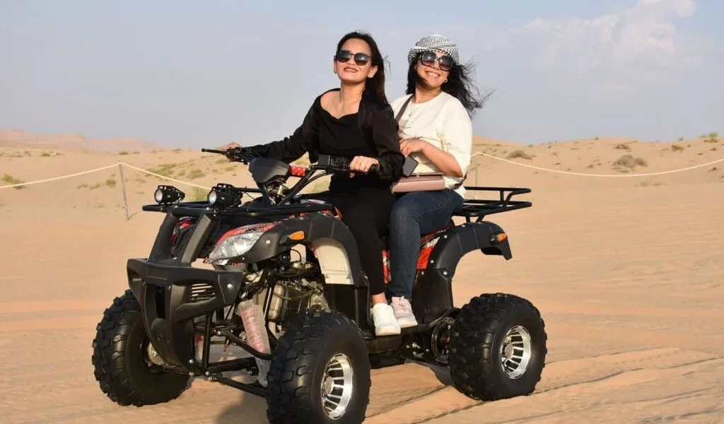 Tourists enjoying a thrilling Desert Safari Dubai experience with dune bashing and camel rides in the heart of the Dubai desert.