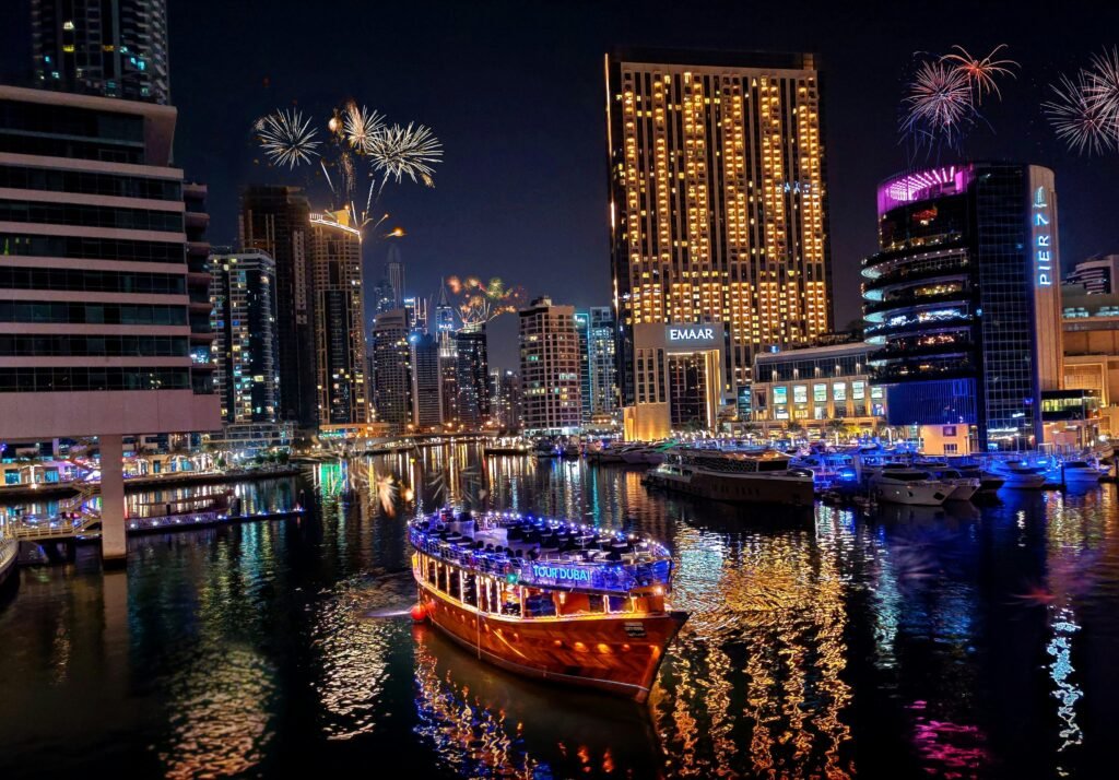 Dubai Creek Dhow Cruise: Stunning Views Await! › Forever Tourism LLC Traditional wooden boat sailing on Dubai Creek during a Dhow Cruise, offering guests scenic views, dining, and entertainment—Dubai Creek Dhow Cruise.