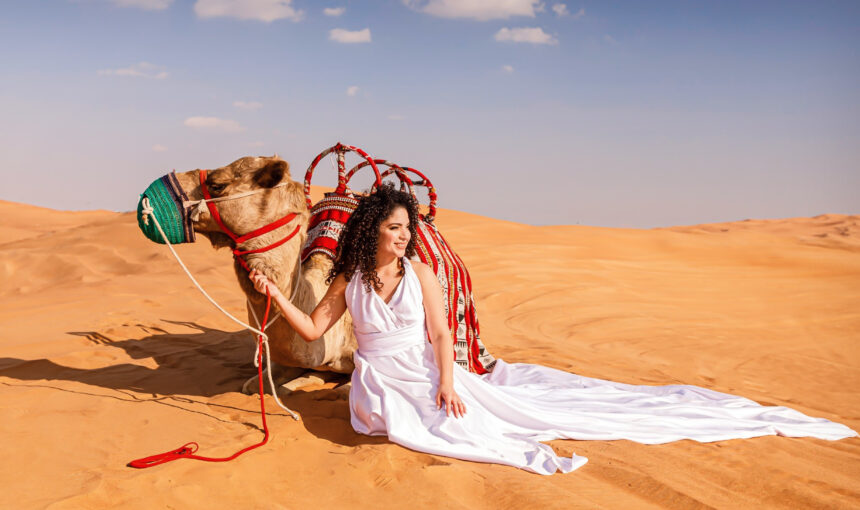Tourists enjoying a thrilling morning desert safari in Dubai with dune bashing and camel rides in the vast Dubai desert. Dubai Tours & UAE Travel Packages​