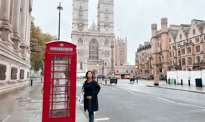 Woman holding passport with UK visa stamp, representing UK visa from UAE and UK tourist visa from Dubai for UAE nationals.