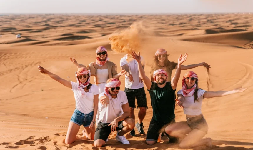 Dubai Desert Safari: 100,000+ Satisfied Thrill Seekers! › Forever Tourism LLC Tourists enjoying a Dubai Desert Safari with dune bashing and sunset views during an evening desert safari tour in Dubai.