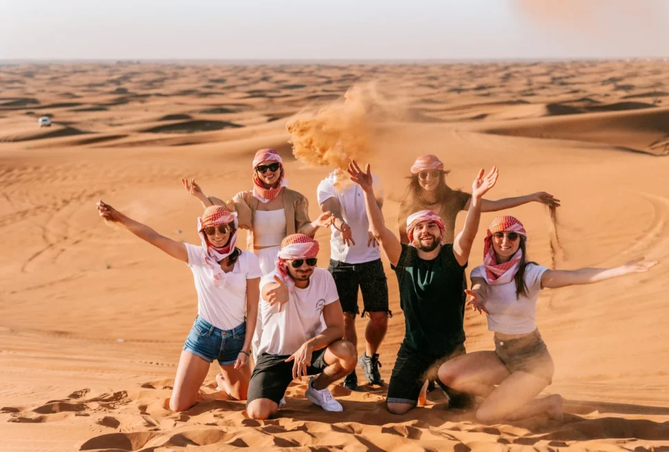 Tourists enjoying a Dubai Desert Safari with dune bashing and sunset views during an evening desert safari tour in Dubai.