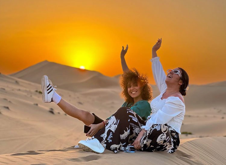 Desert Safari Dubai Deals You Can't Miss › Forever Tourism LLC Tourists enjoying a thrilling Desert Safari Dubai ride with scenic desert Dubai dunes in the background – best deals from Dubai.
