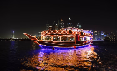 Traditional boat on a dhow cruise marina with dinner, showcasing waterfront views, elegant dining, and serene evening ambiance.