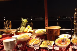 Guests enjoying a scenic creek dhow cruise with dinner aboard a traditional dhow during a magical creek dinner cruise.