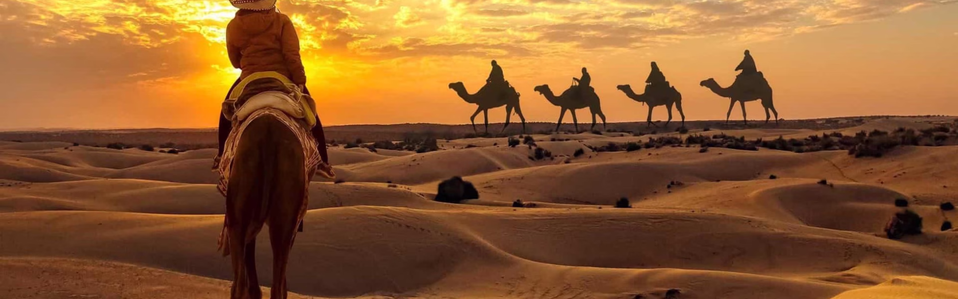 Tourists enjoying dune bashing during an evening desert safari Dubai – part of a top-rated desert safari Dubai experience.