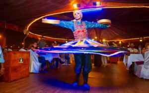 Traditional dhow boat set for a marina dhow dinner cruise at Dubai Marina, featuring glowing lights, waterfront views, and exclusive dinner deals.