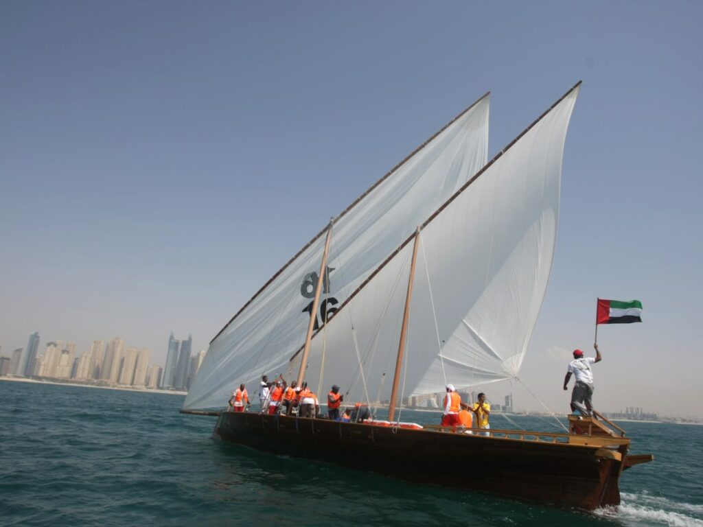 sports in the United Arab Emirates – traditional Emirati men watching camel race