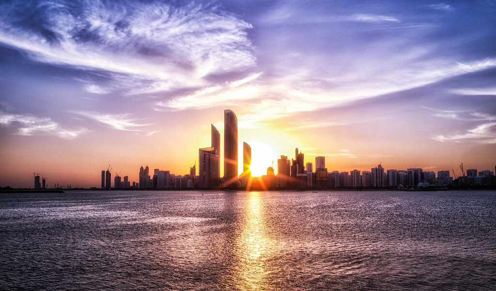 Golden Sunrise and Sunset in Abu Dhabi over city skyline