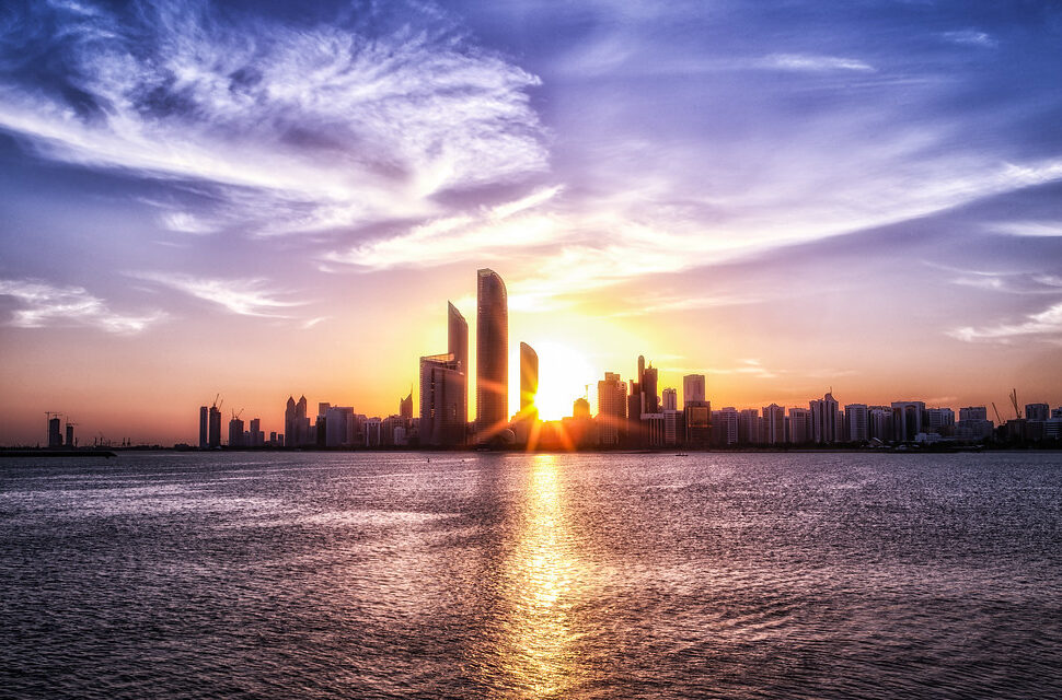 Golden Sunrise and Sunset in Abu Dhabi over city skyline