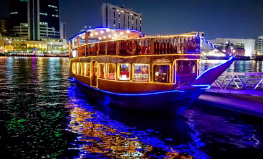 Traditional dhow at Marina during sunset offering a unique dhow cruise dinner Marina with buffet and waterfront views.