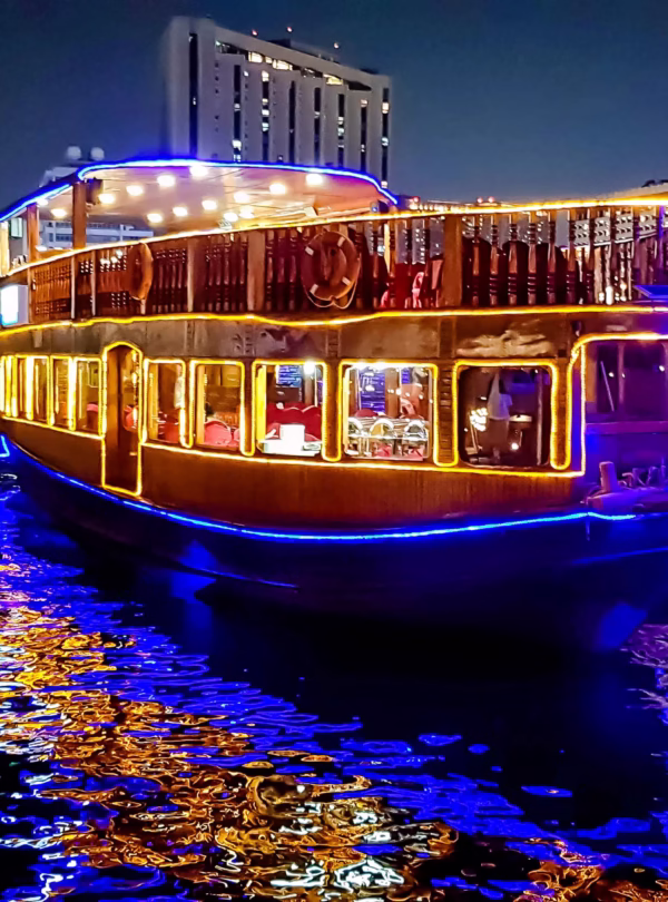 Traditional dhow at Marina during sunset offering a unique dhow cruise dinner Marina with buffet and waterfront views.