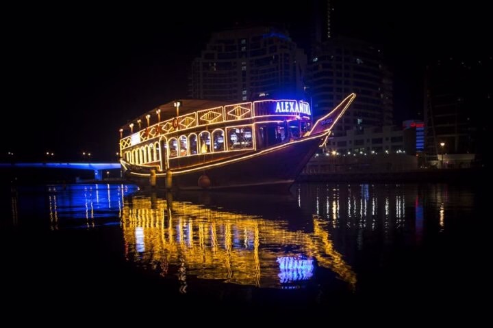 Guests enjoying a scenic Dubai Marina dinner cruise with elegant dining setup during a cruise dinner Dubai under city lights.