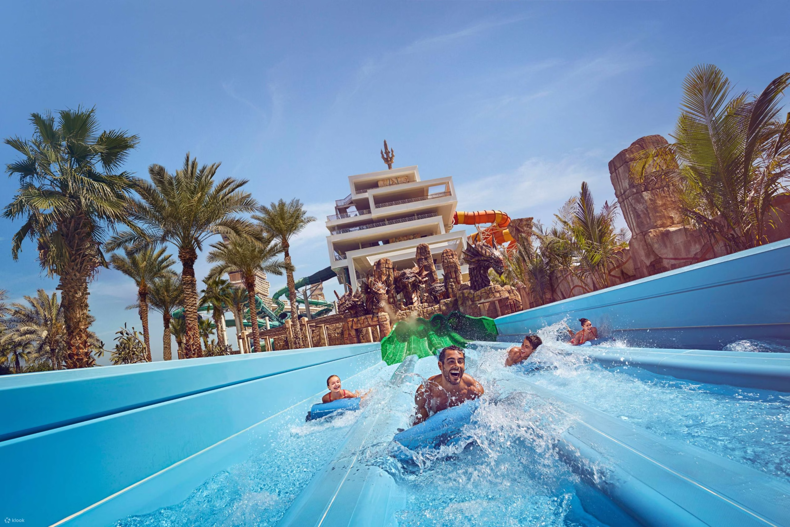 Families enjoying water slides and attractions at Atlantis Water Park, Aquaventure World – get your Aquaventure Waterpark Tickets today.