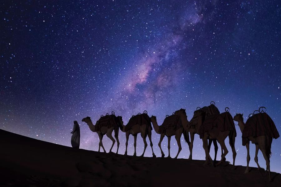 Campfire under the stars during a desert safari Dubai overnight with guests enjoying the night desert safari in a scenic desert safari location.