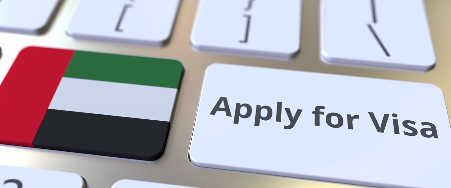 Person filling out a Dubai tourist visa requirement application form online.