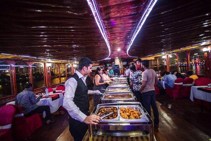 Traditional dhow at Marina during sunset offering a unique dhow cruise dinner Marina with buffet and waterfront views.