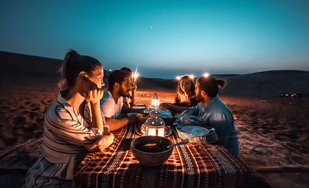 Tourists enjoying a top rated desert safari Dubai UAE with dune bashing, camel rides, and sunset views in a good desert safari in Dubai.