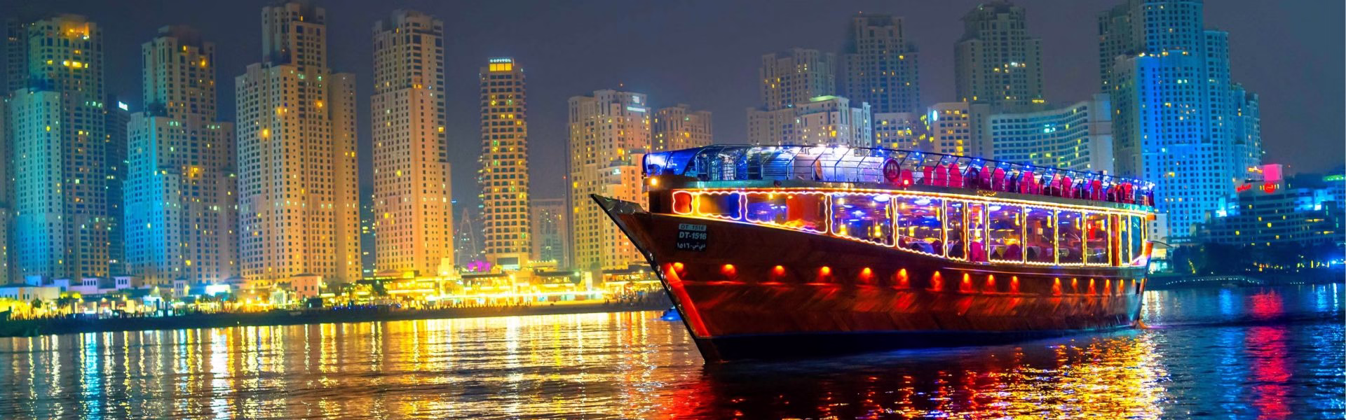 Guests enjoying a scenic Dubai Marina dinner cruise with elegant dining setup during a cruise dinner Dubai under city lights.