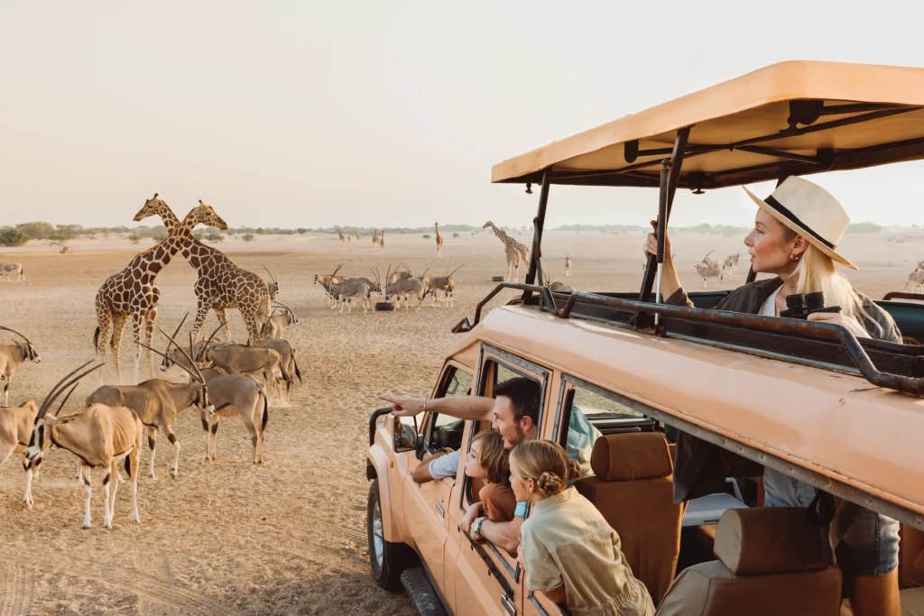 The Top 10 Tours and Day Trips Throughout Abu Dhabi › Forever Tourism LLC Tourists enjoying tours and day trips throughout Abu Dhabi on a desert safari with Forever Tourism guide.