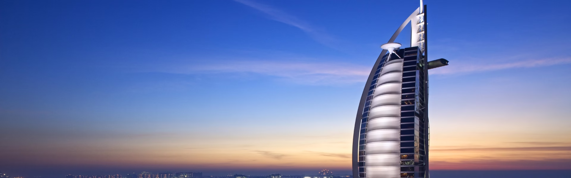 Panoramic view of Burj Al Arab, one of the best hotels in Dubai, showcasing its iconic architecture and luxurious interiors.