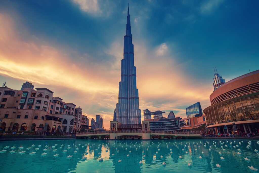 Traveler in Dubai holding passport and visa documents, representing 30 days inside country visa change process without exit.