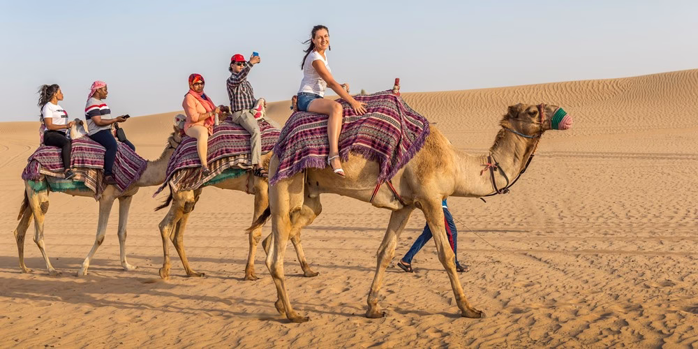 Campfire under the stars during a desert safari Dubai overnight with guests enjoying the night desert safari in a scenic desert safari location.