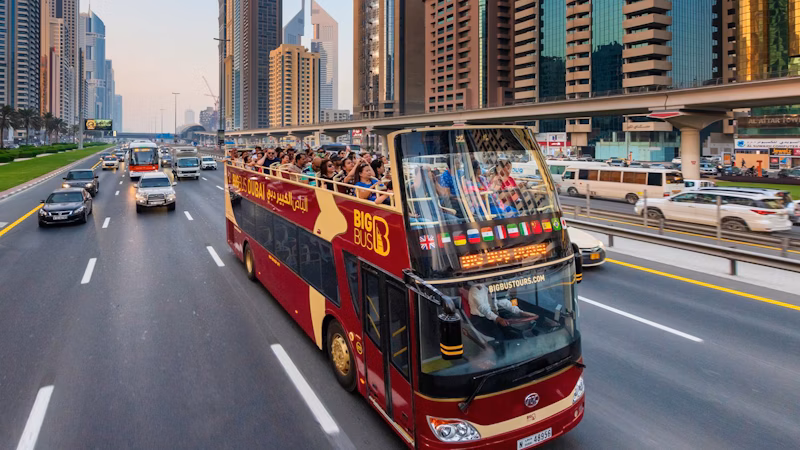 Dubai hop on hop off bus passing iconic landmarks during a Dubai sightseeing city tour.