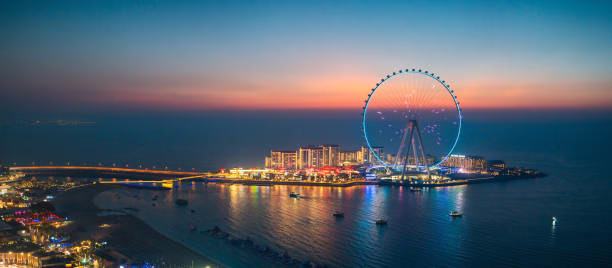 Guests enjoying a dinner cruise Dubai Marina on a traditional dhow with views of the illuminated skyline during a marina cruise Dubai.