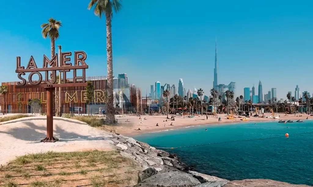 Couple enjoying a sunny winter holiday on a beach during their Dubai holiday 2025, part of a cheap holidays Dubai package.